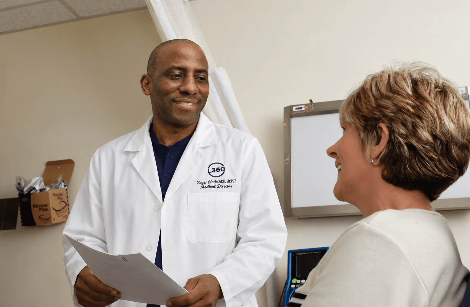 Friendly doctor-patient consultation discussing personal health history and longevity goals